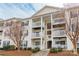 Attractive condo building featuring multiple stories, private balconies, and well-maintained landscaping at 3960 Town Center Rd, Harrisburg, NC 28075