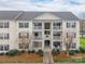 Inviting condo with private balconies, landscaped grounds, and a charming walkway to the entrance at 3960 Town Center Rd, Harrisburg, NC 28075