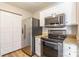 The kitchen is equipped with stainless steel appliances, granite countertops and white cabinets at 3960 Town Center Rd, Harrisburg, NC 28075