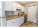 The kitchen features stainless steel appliances, granite countertops and white cabinets at 3960 Town Center Rd, Harrisburg, NC 28075