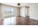 Bright living room with hardwood floors, modern fan, and sliding door to balcony at 3960 Town Center Rd, Harrisburg, NC 28075