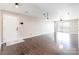 Open-concept living space with hardwood floors, recessed lights, and a sliding glass door to balcony at 3960 Town Center Rd, Harrisburg, NC 28075