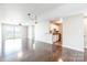 Sunlit living room offering hardwood floors and seamless transition to the kitchen at 3960 Town Center Rd, Harrisburg, NC 28075