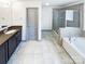 Clean bathroom featuring double sinks, a walk-in shower, and a soaking tub at 5006 Brodie Ln, Fort Mill, SC 29707