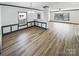 Spacious living room featuring hardwood floors, ample natural light, and classic trim work throughout the home at 5006 Brodie Ln, Fort Mill, SC 29707