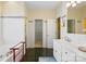 Bathroom featuring tiled walls, black tile floor, and double doors leading to the walk-in closet at 5405 Berrywood Ln, Monroe, NC 28110