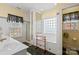 Bright bathroom with decorative glass block window and black and white tile accents at 5405 Berrywood Ln, Monroe, NC 28110
