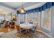 Bright breakfast nook with large windows, pendant lighting, and seating for four offers a cozy space for dining at 5405 Berrywood Ln, Monroe, NC 28110