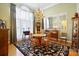 Elegant dining room with hardwood floors, chandelier, and large windows, perfect for entertaining and Gathering meals at 5405 Berrywood Ln, Monroe, NC 28110