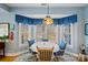 Charming breakfast nook featuring a colorful Tiffany-style lamp and seating for six at 5405 Berrywood Ln, Monroe, NC 28110