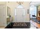 Grand foyer boasts tile floors, chandelier, and elegant front door with sidelights at 5405 Berrywood Ln, Monroe, NC 28110