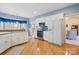 Well-lit kitchen boasts white cabinets, modern appliances, and hardwood floors, blending functionality with classic style at 5405 Berrywood Ln, Monroe, NC 28110