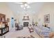 Spacious living room featuring fireplace, ceiling fans, and neutral carpet at 5405 Berrywood Ln, Monroe, NC 28110