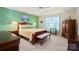 Spacious main bedroom features green accent walls, offering ample natural light and a serene private space at 5405 Berrywood Ln, Monroe, NC 28110
