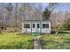 Charming shed with double doors and black shutters, surrounded by landscaping at 5405 Berrywood Ln, Monroe, NC 28110