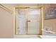 Shower unit with gold trim and sliding doors at 5405 Berrywood Ln, Monroe, NC 28110