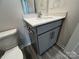 Bathroom featuring a gray vanity, quartz countertop, chrome faucet, and luxury vinyl plank flooring at 586 N Sparkleberry St, Chester, SC 29706