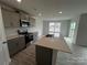Kitchen featuring a central island, gray cabinets, and stainless steel appliances at 586 N Sparkleberry St, Chester, SC 29706