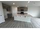 Kitchen with gray cabinetry, quartz countertops, stainless steel appliances, and vinyl plank flooring at 586 N Sparkleberry St, Chester, SC 29706