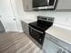 Kitchen features stainless steel appliances, quartz countertops and gray cabinets at 586 N Sparkleberry St, Chester, SC 29706