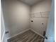 Bright laundry room features gray vinyl flooring, wire shelving and neutral walls at 586 N Sparkleberry St, Chester, SC 29706