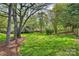 Exterior of home featuring a spacious, green backyard and deck at 6008 Nuthatch Ct, Charlotte, NC 28277