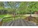 Wooden deck overlooking a lush, green backyard with a wooden fence at 6008 Nuthatch Ct, Charlotte, NC 28277