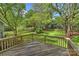 Wooden deck overlooking a lush, green backyard with a wooden fence at 6008 Nuthatch Ct, Charlotte, NC 28277