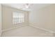 Well-lit bedroom with neutral walls, carpet, and window with blinds at 6008 Nuthatch Ct, Charlotte, NC 28277