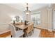 Bright dining room with hardwood floors, modern chandelier, and a large window at 6008 Nuthatch Ct, Charlotte, NC 28277