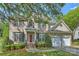 Charming two-story brick home with a manicured lawn and a two-car attached garage at 6008 Nuthatch Ct, Charlotte, NC 28277
