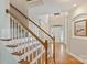 Open foyer showcasing hardwood floors, staircase with white railings, and an arched entryway at 6008 Nuthatch Ct, Charlotte, NC 28277