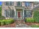 Welcoming front door with white columns, dark shutters, and steps leading to a landscaped yard at 6008 Nuthatch Ct, Charlotte, NC 28277