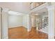 Spacious living room with hardwood floors and a view of the staircase at 6008 Nuthatch Ct, Charlotte, NC 28277