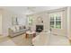 Cozy living room with a fireplace, neutral paint, large windows, and a comfortable seating arrangement at 6008 Nuthatch Ct, Charlotte, NC 28277