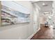 Hallway with hardwood floors leading to a living room featuring a coffered ceiling at 608 Austin Dr, Charlotte, NC 28213