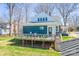 A spacious backyard features a wooden deck and lush lawn at 704 N Main Ave, Newton, NC 28658