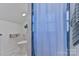 View of a bathroom with clean white walls and marble flooring featuring a toilet and storage basket at 704 N Main Ave, Newton, NC 28658