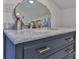 Bathroom vanity with marble countertop, stylish faucet, brushed gold hardware, and a unique oval mirror at 704 N Main Ave, Newton, NC 28658
