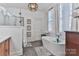 Bright bathroom features a modern tub, glass shower, and stylish fixtures at 704 N Main Ave, Newton, NC 28658