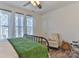 Bedroom features a full-size window, comfortable seating, a bassinet, and ample natural light at 704 N Main Ave, Newton, NC 28658