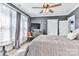 Bedroom featuring a ceiling fan, nice windows, and neutral decor at 704 N Main Ave, Newton, NC 28658