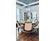 Well-lit dining room with a round table, dining chairs, hardwood floors and views to kitchen at 704 N Main Ave, Newton, NC 28658