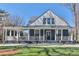 Charming blue two-story home featuring a welcoming porch and a well-manicured front lawn at 704 N Main Ave, Newton, NC 28658