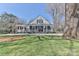 Inviting home with large front porch, providing curb appeal with manicured lawn at 704 N Main Ave, Newton, NC 28658