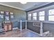 View of a hallway with wood-paneled walls and staircase overlooking the first floor and exterior scenery at 704 N Main Ave, Newton, NC 28658
