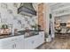 Stylish kitchen equipped with stainless steel appliances, brick accents, and tiled backsplash at 704 N Main Ave, Newton, NC 28658