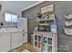 Laundry area with gray accent wall, white cabinets and modern washer and dryer set at 704 N Main Ave, Newton, NC 28658
