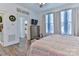 Comfortable main bedroom with a ceiling fan, large windows, and relaxing decor at 704 N Main Ave, Newton, NC 28658