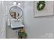 Charming powder room with vintage-style sink and decorative wreath at 704 N Main Ave, Newton, NC 28658